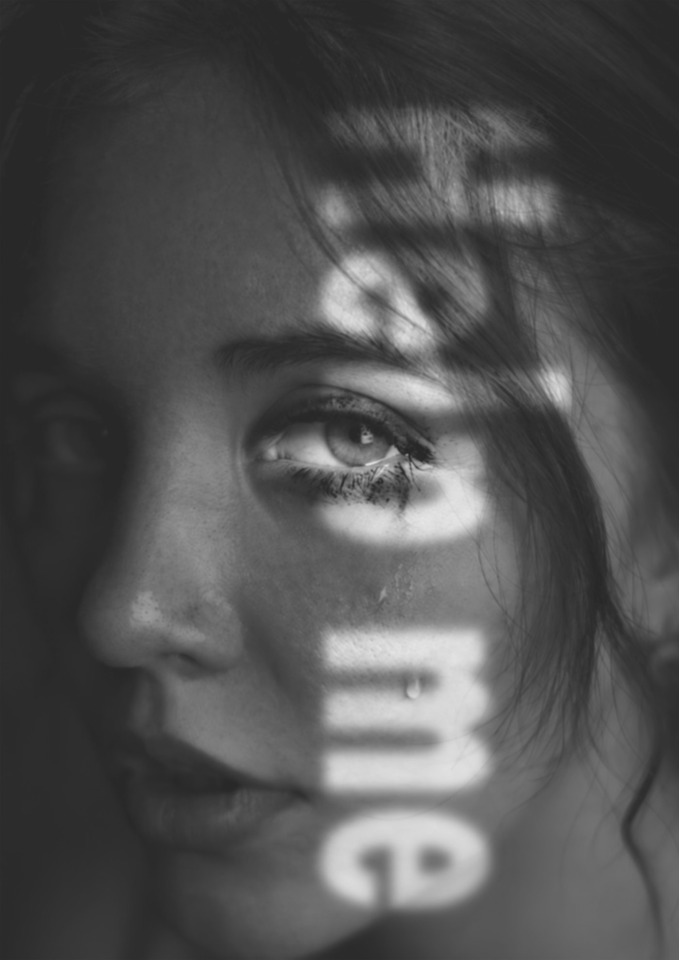Black and white portrait poster with projected type reading help me